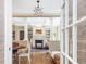 View into open-concept dining and living spaces with hardwood floors, columns, and bright lighting at 1624 Hopkins Rd, Bahama, NC 27503