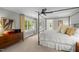 Main bedroom with four-poster bed, dresser, and natural light streaming through the large windows at 1624 Hopkins Rd, Bahama, NC 27503