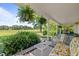 Inviting front porch featuring comfortable seating and hanging ferns overlooking the property's scenic landscape at 1624 Hopkins Rd, Bahama, NC 27503