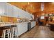Bright tack room with white cabinets, wet bar, and wood-paneled walls, designed for convenience and functionality at 1624 Hopkins Rd, Bahama, NC 27503