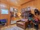 Tack room featuring a leather sofa, saddle racks, and riding equipment storage for equestrian needs at 1624 Hopkins Rd, Bahama, NC 27503