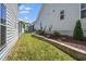 Well-maintained backyard featuring a stone retaining wall and lush lawn at 1705 Main Divide Dr, Wake Forest, NC 27587