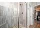 Beautiful bathroom shower with neutral toned tile surround, and stone pebble base at 1705 Main Divide Dr, Wake Forest, NC 27587