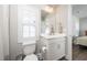 Bright bathroom featuring a toilet, white vanity, and plantation shutters at 1705 Main Divide Dr, Wake Forest, NC 27587