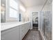 Bathroom featuring double sinks, modern fixtures, and a glass-enclosed shower at 1705 Main Divide Dr, Wake Forest, NC 27587