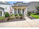 Inviting home showcasing a front porch, manicured yard, and American flag at 1705 Main Divide Dr, Wake Forest, NC 27587