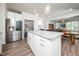 Modern kitchen featuring a center island, stainless steel appliances, and a pantry for ample storage space at 1705 Main Divide Dr, Wake Forest, NC 27587