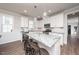Modern kitchen with white cabinets, granite countertops, stainless steel appliances, and a center island at 1705 Main Divide Dr, Wake Forest, NC 27587