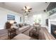 Bright living room features a fireplace, ceiling fan, and plenty of natural light at 1705 Main Divide Dr, Wake Forest, NC 27587