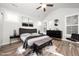 A stylish main bedroom with a plush bed, modern furniture, and plenty of natural light at 1705 Main Divide Dr, Wake Forest, NC 27587