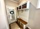 Cozy mudroom features a bench with storage, a coat rack, and an inviting wreath on the door at 1705 Main Divide Dr, Wake Forest, NC 27587