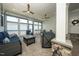 Relaxing screened patio with comfortable blue seating and stylish ceiling fans at 1705 Main Divide Dr, Wake Forest, NC 27587