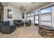 Inviting screened porch with plush blue seating and an outdoor fire pit at 1705 Main Divide Dr, Wake Forest, NC 27587