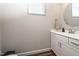 Powder room featuring a sleek vanity, round mirror, and modern finishes at 1705 Main Divide Dr, Wake Forest, NC 27587