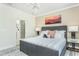 Comfortable bedroom featuring a stylish gray bed frame, mountain art and ensuite bathroom at 1816 Gazania Dr, Fuquay Varina, NC 27526