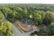 Aerial view of modern home featuring brick and green sheathing, located in lush neighborhood at 1925 Hunting Ridge Rd, Raleigh, NC 27615
