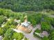 New construction aerial view highlighting wooded lot, pond, and golf course at 1925 Hunting Ridge Rd, Raleigh, NC 27615