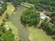 Aerial view of neighborhood highlighting golf course, lake, and well-maintained landscaping at 1925 Hunting Ridge Rd, Raleigh, NC 27615