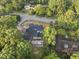 An aerial view showcases a new home with a pool under construction in a wooded neighborhood at 1925 Hunting Ridge Rd, Raleigh, NC 27615
