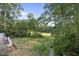 View of an unfinished pool and backyard with a golf course in the distance at 1925 Hunting Ridge Rd, Raleigh, NC 27615
