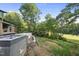 View of an unfinished pool and backyard with a golf course in the distance at 1925 Hunting Ridge Rd, Raleigh, NC 27615
