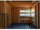 Unfinished bathroom with exposed wood framing, modern windows, and blue waterproof flooring membrane at 1925 Hunting Ridge Rd, Raleigh, NC 27615