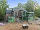 Modern two story home featuring brick and green sheathing under construction at 1925 Hunting Ridge Rd, Raleigh, NC 27615