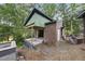 Brick home exterior under construction showing an unfinished patio and backyard area at 1925 Hunting Ridge Rd, Raleigh, NC 27615
