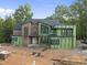 Modern two story home featuring brick and green sheathing under construction at 1925 Hunting Ridge Rd, Raleigh, NC 27615