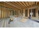 Unfinished garage with stud framing, concrete floor, and construction materials visible at 1925 Hunting Ridge Rd, Raleigh, NC 27615