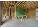 Unfinished garage with visible framing and construction materials on the concrete floor at 1925 Hunting Ridge Rd, Raleigh, NC 27615