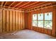 A view of the framed interior featuring an expansive window with natural light illuminating space at 1925 Hunting Ridge Rd, Raleigh, NC 27615