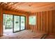Unfinished room with sliding glass doors leading to an outdoor view and a window on a wall at 1925 Hunting Ridge Rd, Raleigh, NC 27615