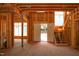 Unfinished interior framing reveals the structure, featuring stairs and a welcoming front door at 1925 Hunting Ridge Rd, Raleigh, NC 27615