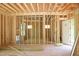 New construction with exposed framing and doorway, showcasing an open floor plan and a blank canvas for customization at 1925 Hunting Ridge Rd, Raleigh, NC 27615