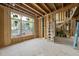 A large room is under construction, featuring a large window and framing with staircase in view at 1925 Hunting Ridge Rd, Raleigh, NC 27615