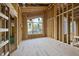 Unfinished living room featuring large windows and a wood frame, ready for customization at 1925 Hunting Ridge Rd, Raleigh, NC 27615
