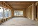 Bright, unfinished living room with large windows offering natural light and views at 1925 Hunting Ridge Rd, Raleigh, NC 27615