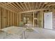 Unfinished living room framed featuring an open design and multiple windows, ready for customization at 1925 Hunting Ridge Rd, Raleigh, NC 27615
