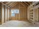 Framed living room with exposed wood framing with natural light streaming through the windows at 1925 Hunting Ridge Rd, Raleigh, NC 27615