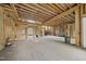 Large unfinished living room showcasing the wood framing, staircase and backyard access at 1925 Hunting Ridge Rd, Raleigh, NC 27615