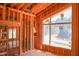 Unfinished living room showcases exposed framing, large windows, and an open concept layout, ready for customization at 1925 Hunting Ridge Rd, Raleigh, NC 27615