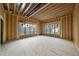 Large unfinished living room framed, featuring multiple windows, offering abundant natural light at 1925 Hunting Ridge Rd, Raleigh, NC 27615