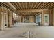 Expansive unfinished living room with wood framing, high ceilings, and backyard access at 1925 Hunting Ridge Rd, Raleigh, NC 27615
