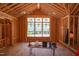 Unfinished living room displays exposed wood framing, large windows, and high vaulted ceilings at 1925 Hunting Ridge Rd, Raleigh, NC 27615