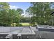 View of a pool construction site with a golf course and trees in the background at 1925 Hunting Ridge Rd, Raleigh, NC 27615