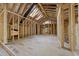 Large room with framed windows and skylights, offering natural light and a spacious under-construction interior at 1925 Hunting Ridge Rd, Raleigh, NC 27615