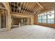 Room framed with exposed beams, featuring natural light, and new construction elements at 1925 Hunting Ridge Rd, Raleigh, NC 27615