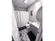 Modern bathroom featuring a gray vanity, herringbone floors, and a shower with a patterned curtain at 201 Joe Gibson Dr, Gibsonville, NC 27249