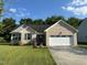 Charming brick home with a well-manicured lawn and an attached two-car garage at 201 Joe Gibson Dr, Gibsonville, NC 27249